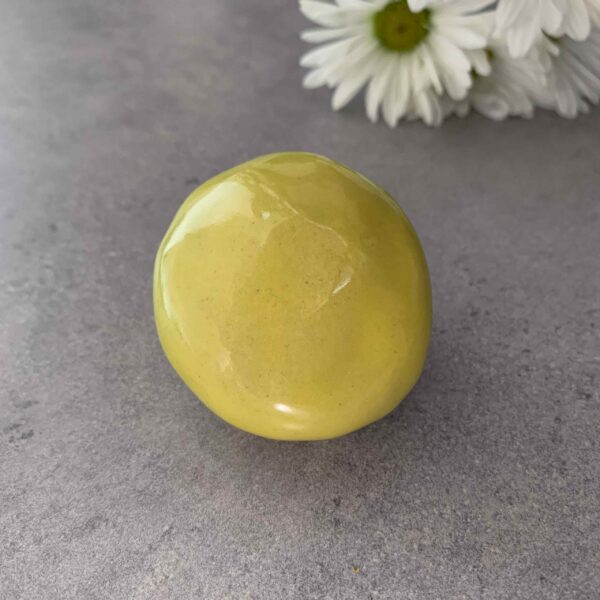 Reliquary in the shape of a round butter yellow pebble