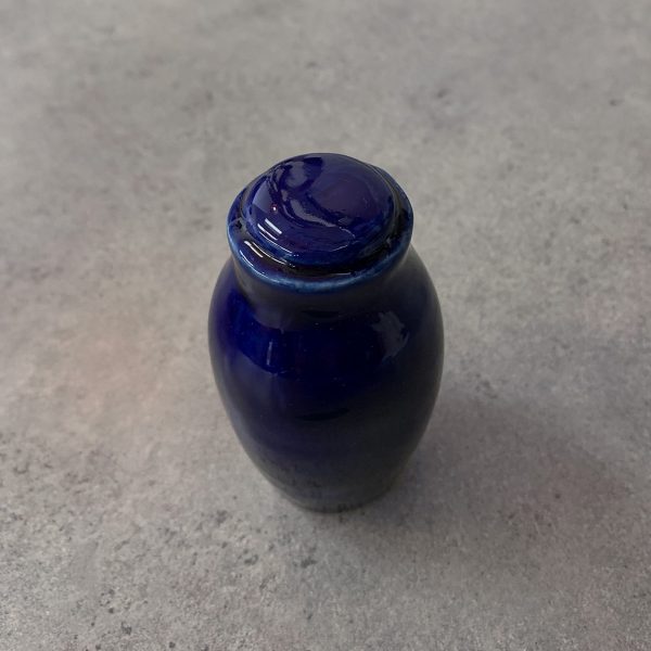 Reliquary in the shape of a small royal blue elongated urn